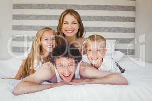 Portrait of family resting on bed