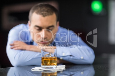 Worried businessman drinking a beer