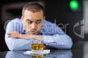 Worried businessman drinking a beer