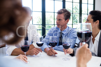 Group of businesspeople drinking wine glass during business lunc