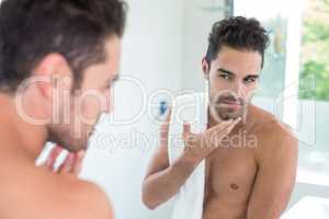 Young man looking in mirror