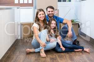 Portrait of smiling family sitting on floor