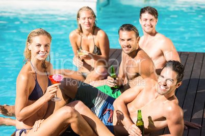 Happy friends enjoying at the swimming pool