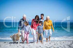 Happy family with their dog at the beach