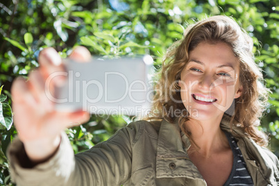 Smiling woman taking selfies