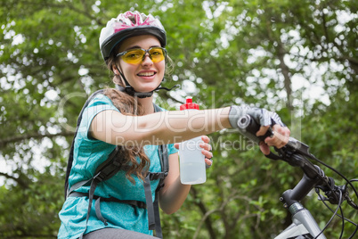 Woman drinking water while cycling