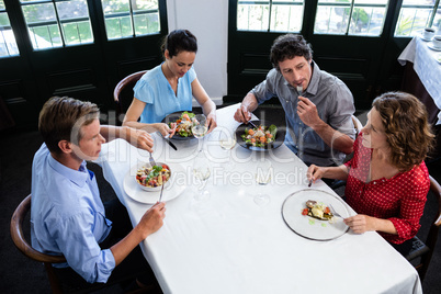 Group of friends talking while having lunch