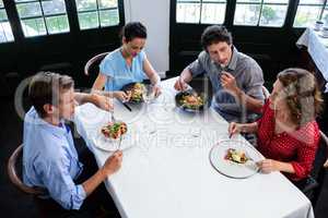 Group of friends talking while having lunch