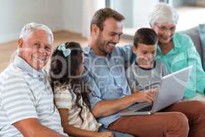 Happy family sitting on sofa