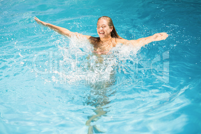 Beautiful woman enjoying in swimming pool