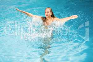 Beautiful woman enjoying in swimming pool