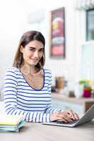 Young woman using laptop at table