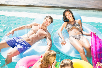 Happy friends enjoying in the swimming pool