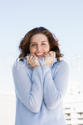 Happy young woman shivering