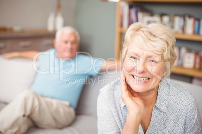 Portrait of happy senior woman with husband at home
