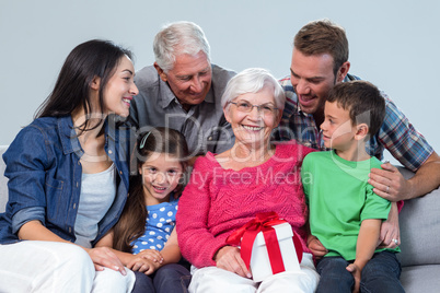 Family giving a gift to grandmother