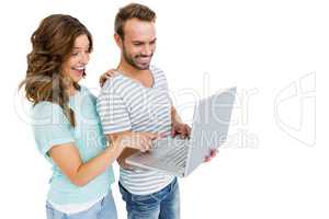 Happy young couple using laptop