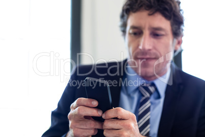 Businessman using his mobile phone at restaurant