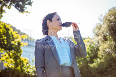 Pretty businesswoman having a glass of wine