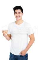 Happy man holding disposable coffee cup smiling at camera