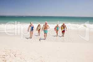 Senior friends holding surfboard