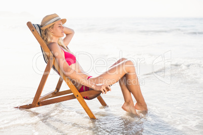 Woman relaxing on an armchair on the beach