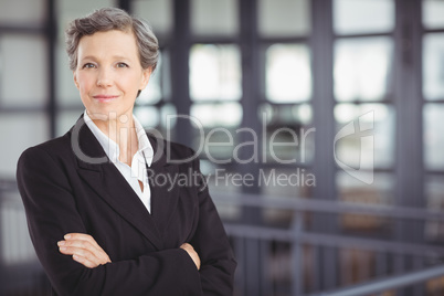 Confident businesswoman standing by railing