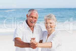 Senior couple dancing on the beach