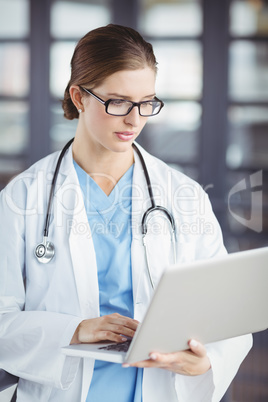 Female doctor working on laptop