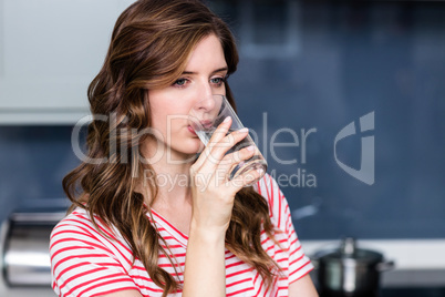 Close-up of beautiful young woman drinking water