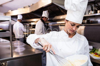 Chef whisking bowl of eggs