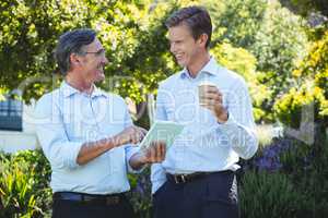 Two businessmen meeting using tablet