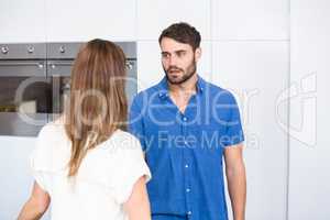 Man looking at wife while arguing