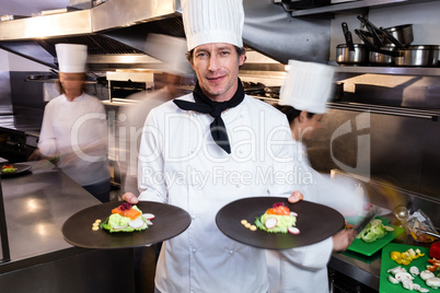 Happy head chef presenting his food plates