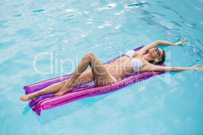 Beautiful young woman relaxing on inflatable raft