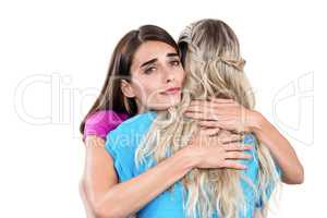 Sad young woman hugging friend