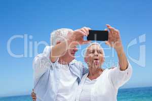 Senior couple taking a selfie and grimacing