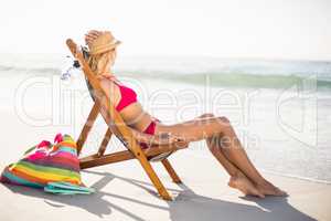 Woman relaxing on an armchair on the beach