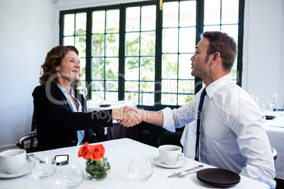 Business colleagues shaking hands after a successful meeting