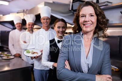 Restaurant manager posing in front of team of staff