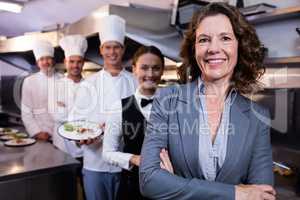Restaurant manager posing in front of team of staff
