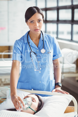 Nurse putting oxygen mask on a female patient