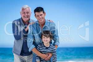 Male family members posing at the beach