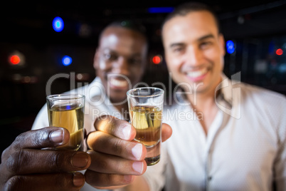 Handsome men drinking together