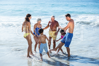 Happy family playing with waves