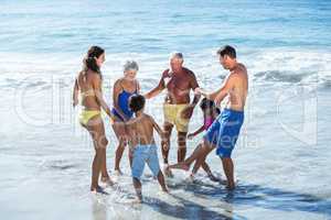 Happy family playing with waves