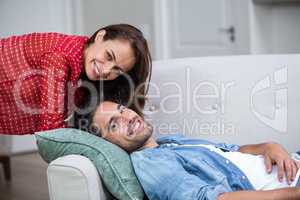 Happy romantic couple relaxing on sofa