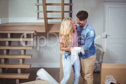 Couple embracing while relocating in new house