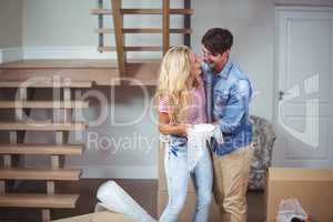 Couple embracing while relocating in new house