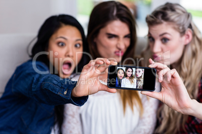Beautiful young female friends taking selfie